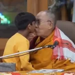 in-a-video-that-has-sparked-controversy-throughout-the-world,-the-dalai-lama-kisses-a-young-indian-kid-and-instructs-him-to-“suck-my-tongue.”